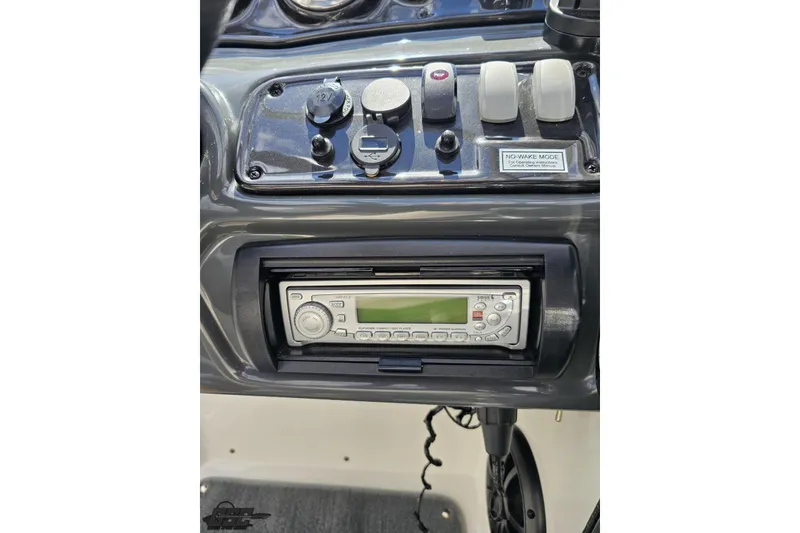 Slide: The Image of Dashboard of a 2007 Yamaha AR230 HO boat featuring a stereo system and control switches. - 60