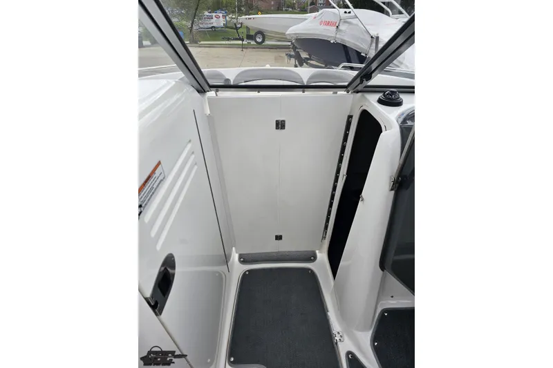 Slide: The Image of 2007 Yamaha Boats AR230 HO interior with closed compartment door and seating area. - 63