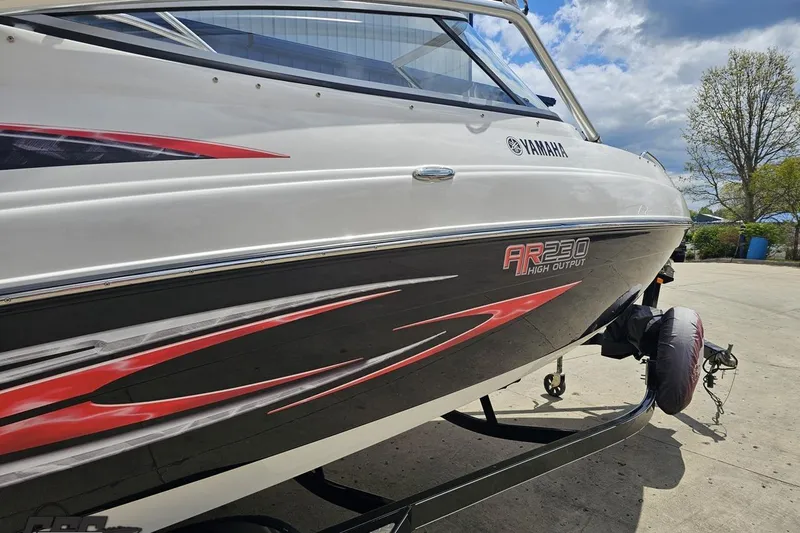 Slide: The Image of 2007 Yamaha Boats AR230 HO on trailer, showcasing sleek design and vibrant graphics. - 7