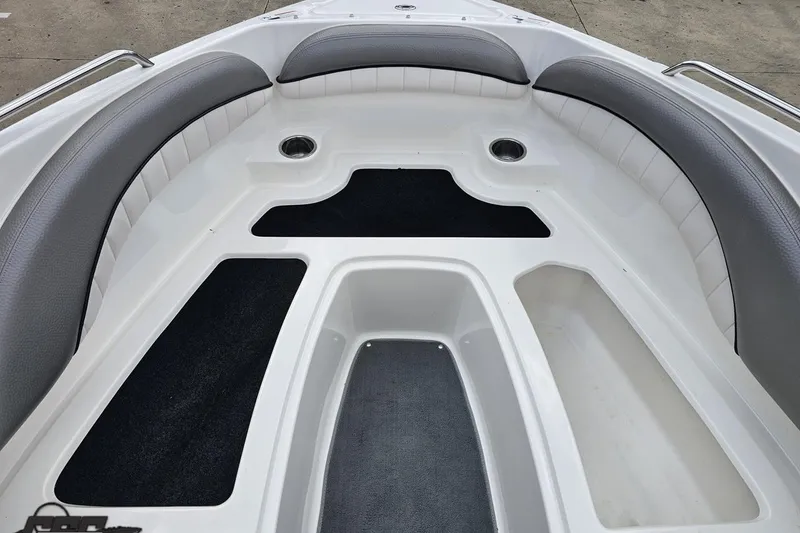 Slide: The Image of 2007 Yamaha Boats AR230 HO bow seating area with gray cushions and storage compartments. - 71