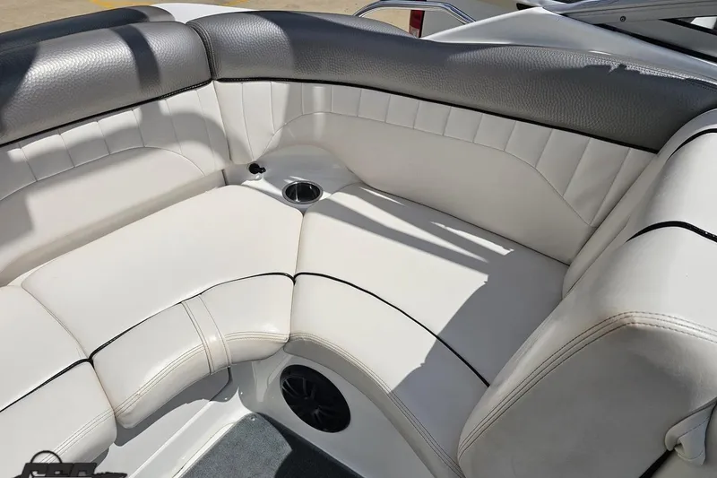 Slide: The Image of 2007 Yamaha Boats AR230 HO interior seating with white upholstery and cup holder. - 78