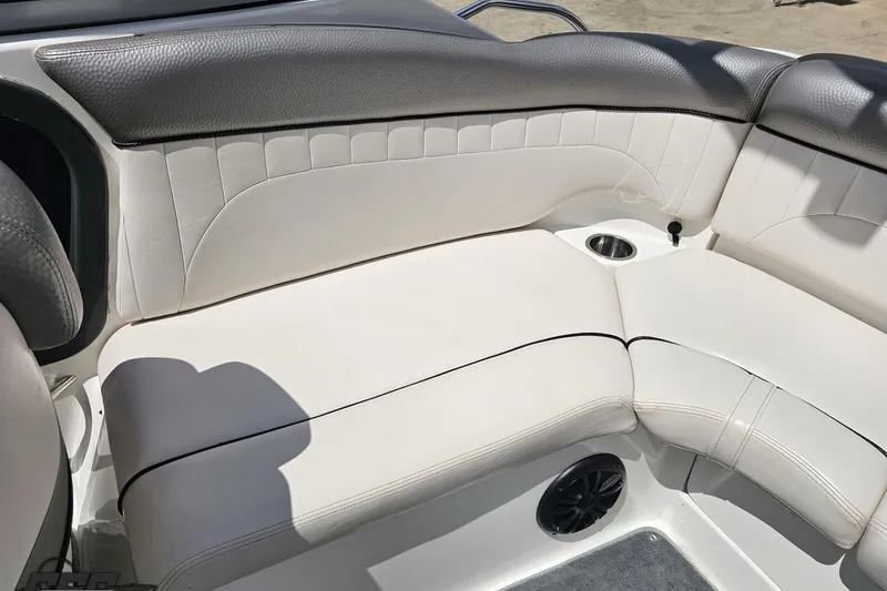 Slide: The Image of 2007 Yamaha Boats AR230 HO interior seating with cup holder and speaker. - 79