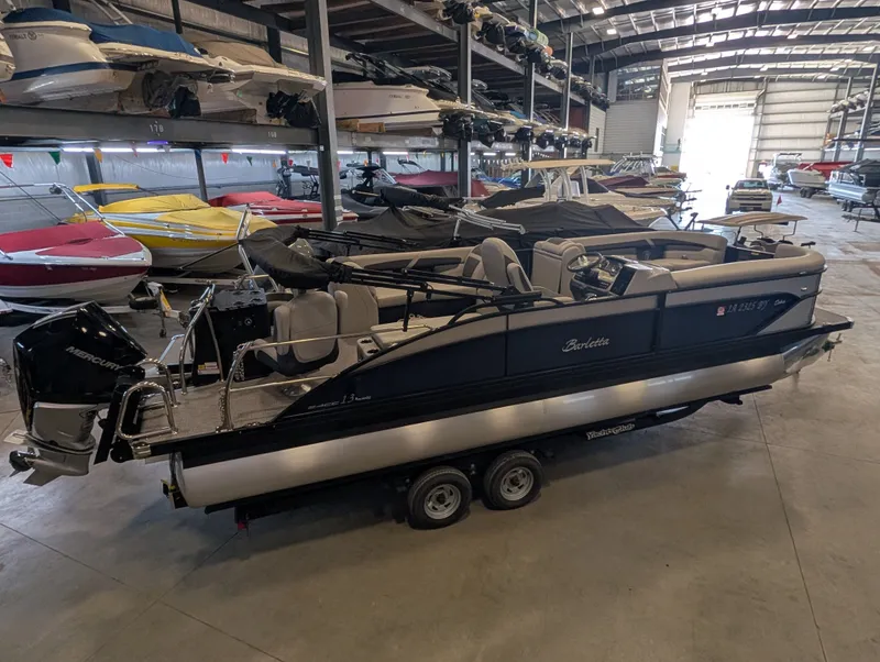 Slide: The Image of 2025 Barletta Cabrio 24CC pontoon boat in storage facility. - 13