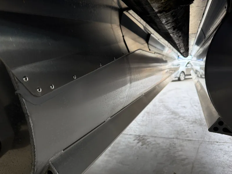 Slide: The Image of Underside of Barletta Cabrio 24CC 2025 boat in a garage. - 24