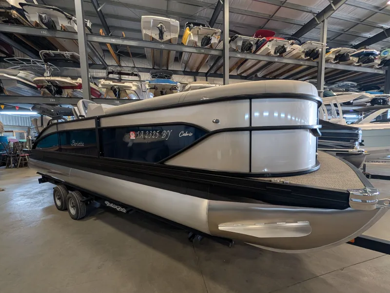 Slide: The Image of 2025 Barletta Cabrio 24CC pontoon boat in storage facility. - 3