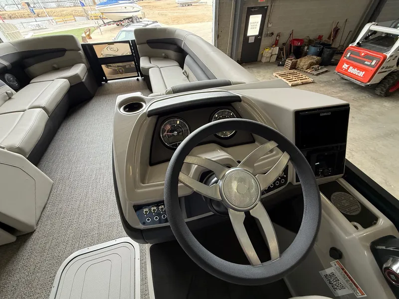 Slide: The Image of Interior of 2025 Barletta Cabrio 24CC with steering wheel and seating. - 6