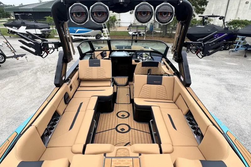 Slide: The Image of Luxurious interior of 2025 MasterCraft X26 boat with tan seating and advanced audio system. - 10