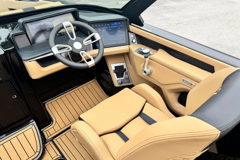 Slide: The Image of Luxurious 2025 MasterCraft X26 boat interior with advanced dashboard and tan leather seating. - 11