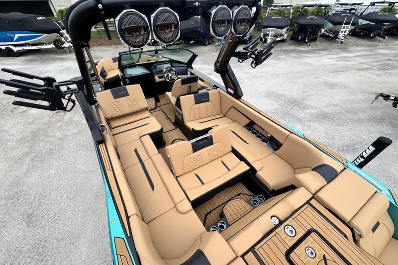 Slide: The Image of 2025 MasterCraft X26 boat interior with luxurious tan seating and advanced audio system. - 20