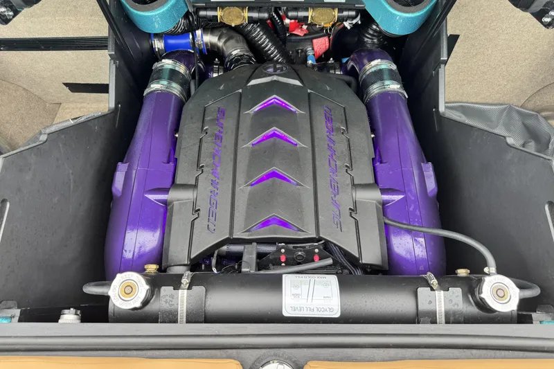 Slide: The Image of Supercharged engine of 2025 MasterCraft X26 boat, featuring vibrant purple components. - 21