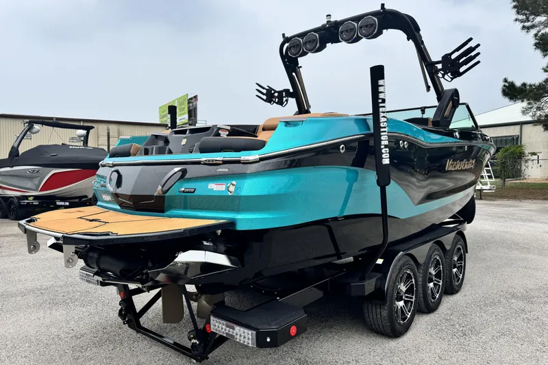 Slide: The Image of 2025 MasterCraft X26 boat on trailer, featuring sleek design and vibrant blue color. - 3