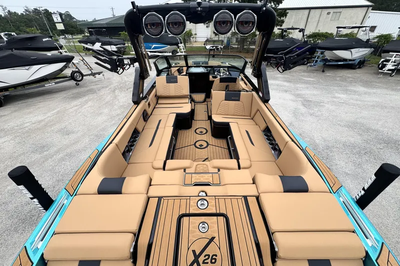 Slide: The Image of 2025 MasterCraft X26 boat interior with tan seating and sleek design. - 9