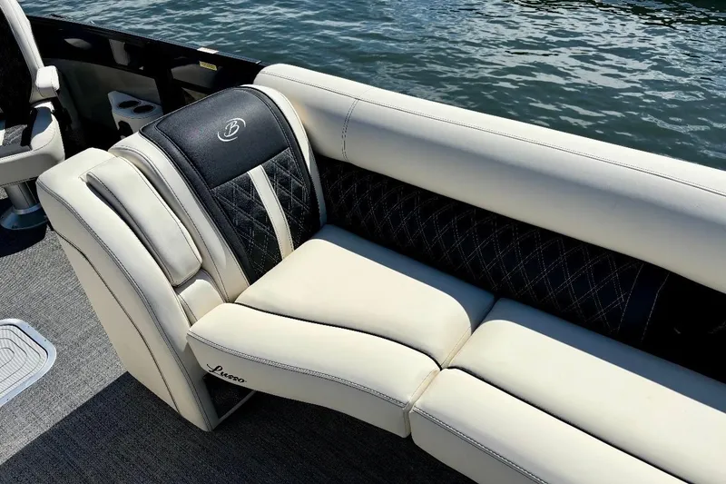 Slide: The Image of Luxurious seating on 2025 Barletta L25UCAT pontoon boat by the water. - 12