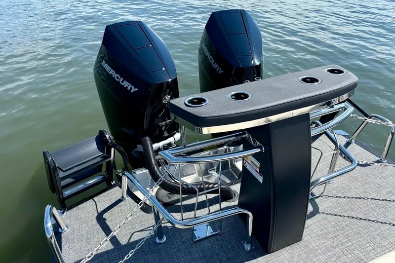 Slide: The Image of 2025 Barletta L25UCAT boat with dual Mercury engines on water. - 4