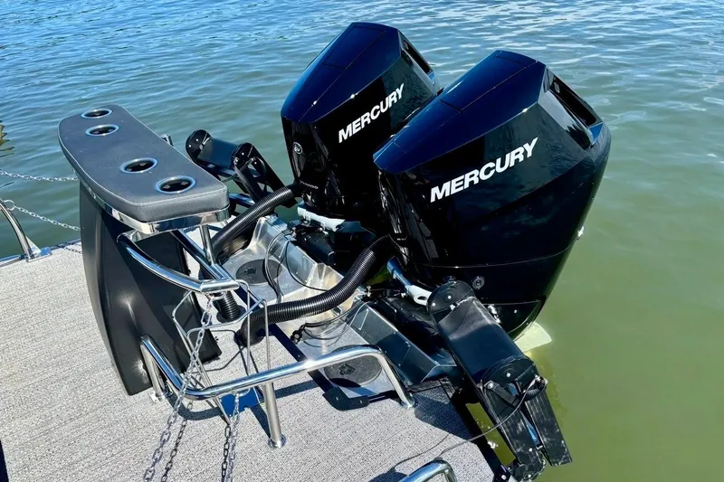Slide: The Image of 2025 Barletta L25UCAT boat with dual Mercury outboard engines on water. - 5