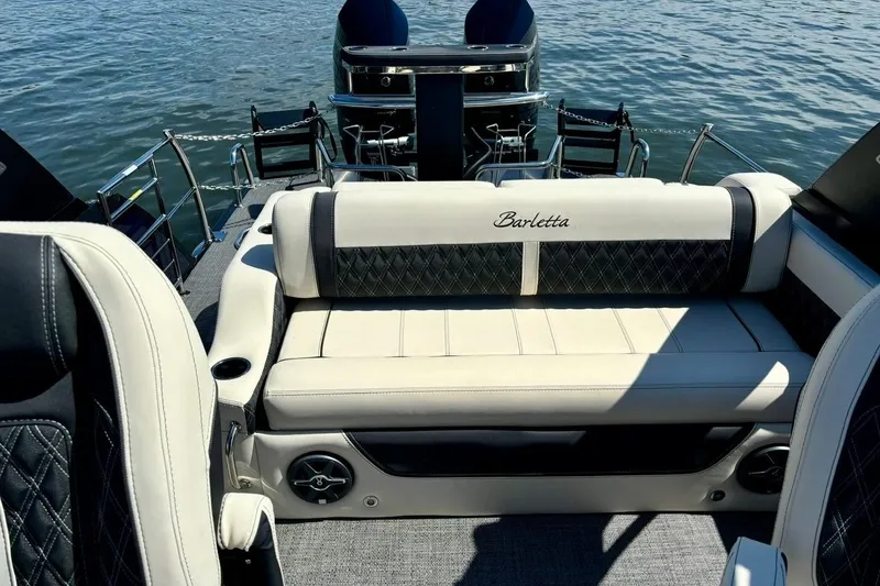 Slide: The Image of 2025 Barletta L25UCAT luxury boat interior with elegant seating on a serene water backdrop. - 6