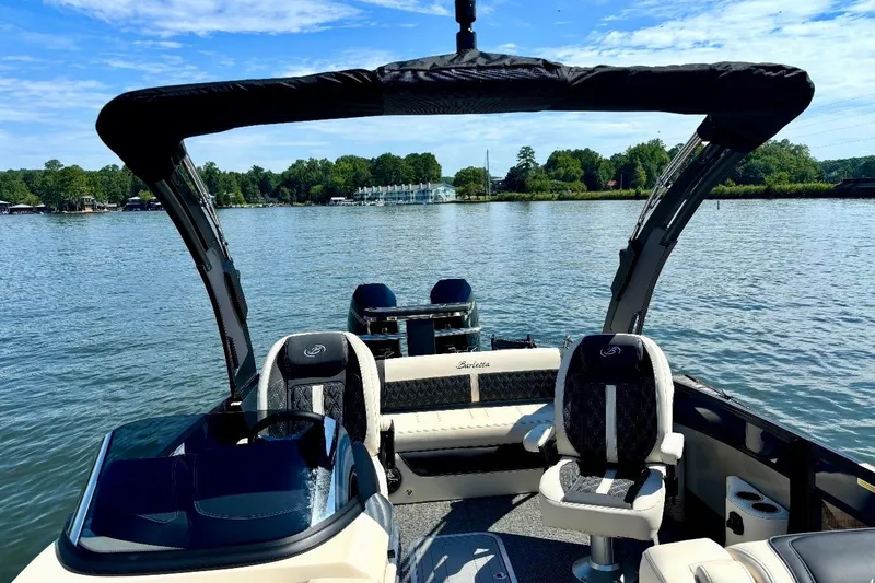 Slide: The Image of 2025 Barletta L25UCAT pontoon boat interior on a serene lake. - 7