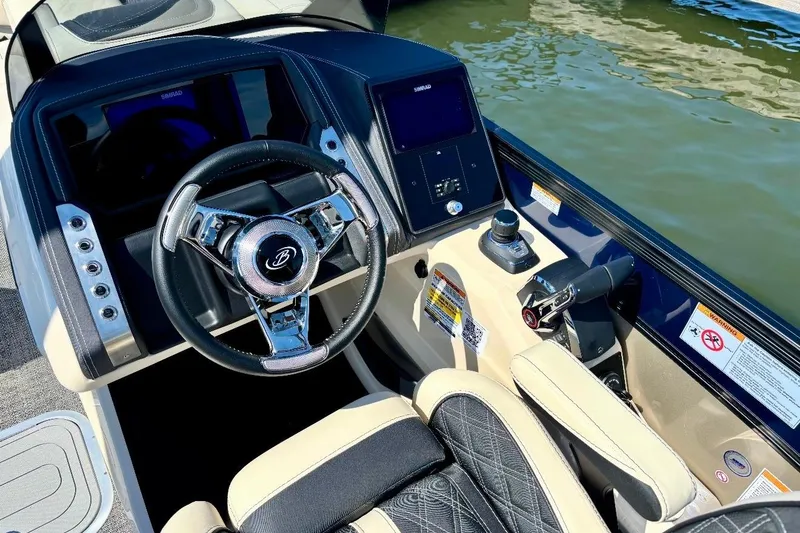 Slide: The Image of 2025 Barletta L25UCAT boat cockpit with steering wheel and control panel. - 8