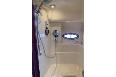 Slide: The Image of 2007 Sea Ray 36 Sedan Bridge cabin with twin beds and striped pillows. - 13