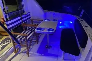 Slide: The Image of 2007 Sea Ray 36 Sedan Bridge yacht interior with blue LED lighting and seating area. - 16
