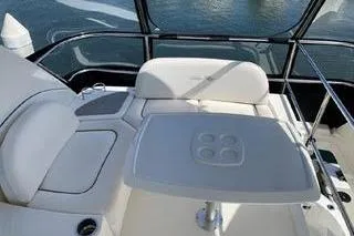 Slide: The Image of 2007 Sea Ray 36 Sedan Bridge yacht interior with seating and table, overlooking water. - 5