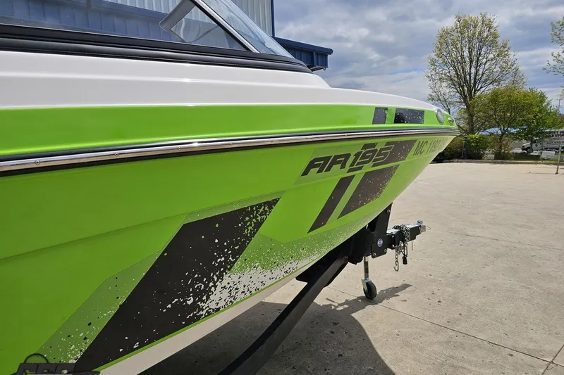 Slide: The Image of 2022 Yamaha AR195 boat in vibrant green, parked outdoors on a sunny day. - 11