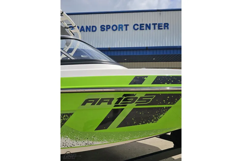 Slide: The Image of 2022 Yamaha AR195 boat with green graphics at a sport center. - 12