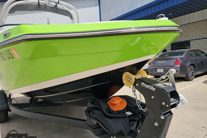 Slide: The Image of 2022 Yamaha Boats AR195 in vibrant green on trailer, parked outdoors. - 14