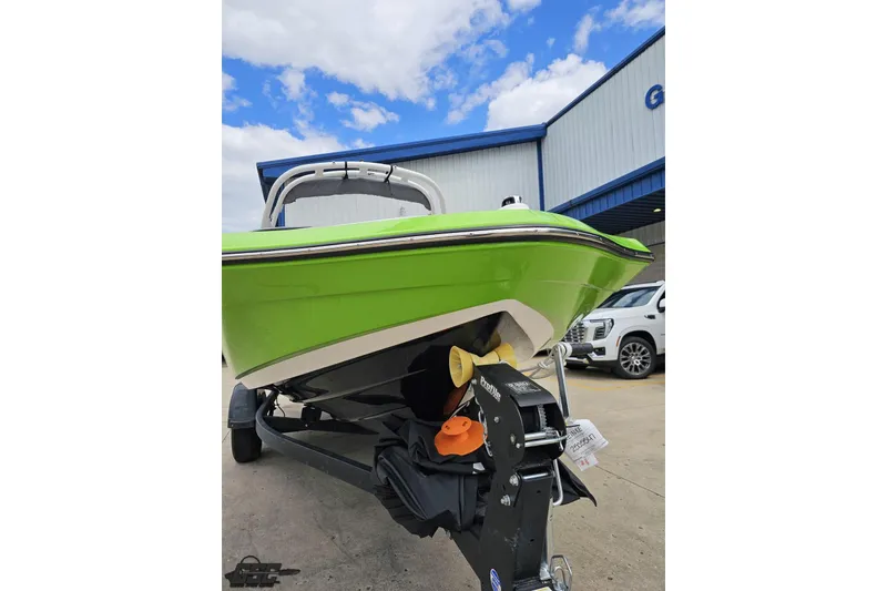 Slide: The Image of 2022 Yamaha Boats AR195 in vibrant green on trailer, parked outdoors. - 15