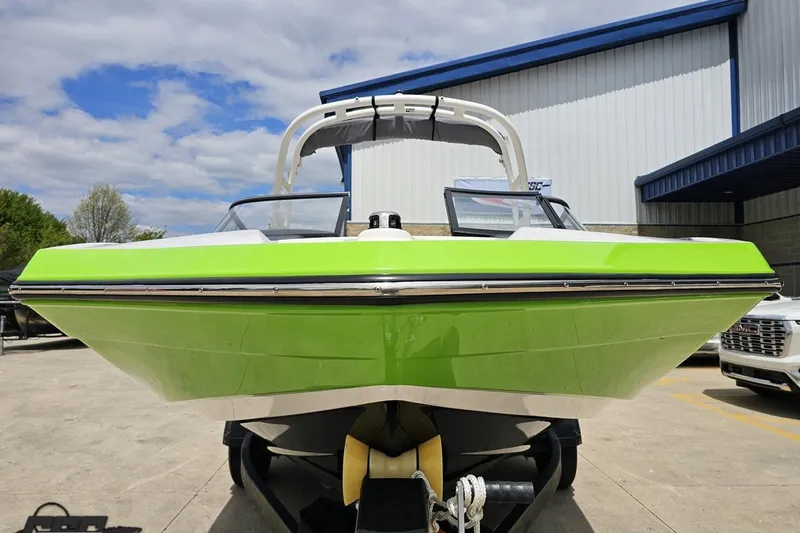 Slide: The Image of 2022 Yamaha Boats AR195 in vibrant green, parked outdoors under a partly cloudy sky. - 16