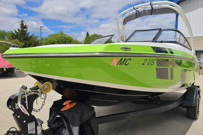 Slide: The Image of 2022 Yamaha Boats AR195 in vibrant green on a trailer, ready for adventure. - 19