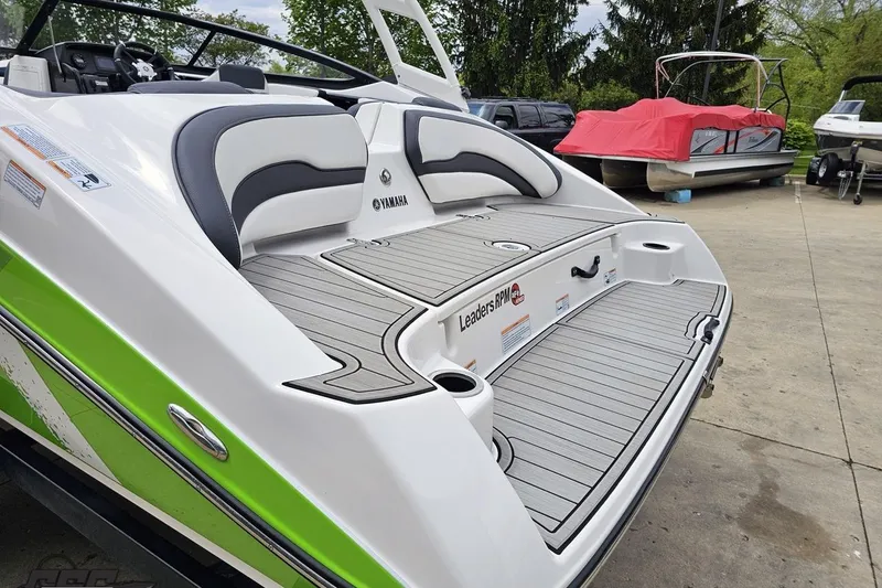 Slide: The Image of 2022 Yamaha Boats AR195 with sleek design and spacious deck, parked outdoors. - 30