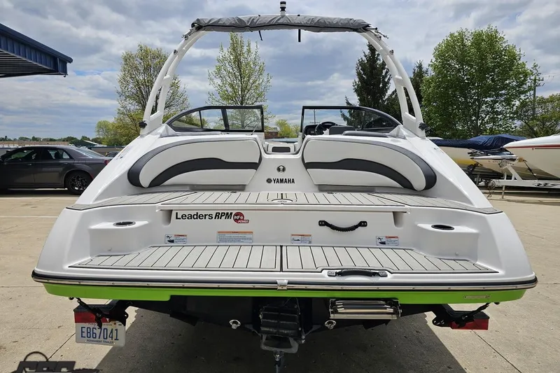 Slide: The Image of 2022 Yamaha Boats AR195, rear view, parked outdoors with swim platform and seating. - 32