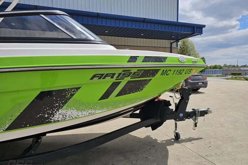 Slide: The Image of 2022 Yamaha Boats AR195 in vibrant green on trailer, parked outdoors. - 4