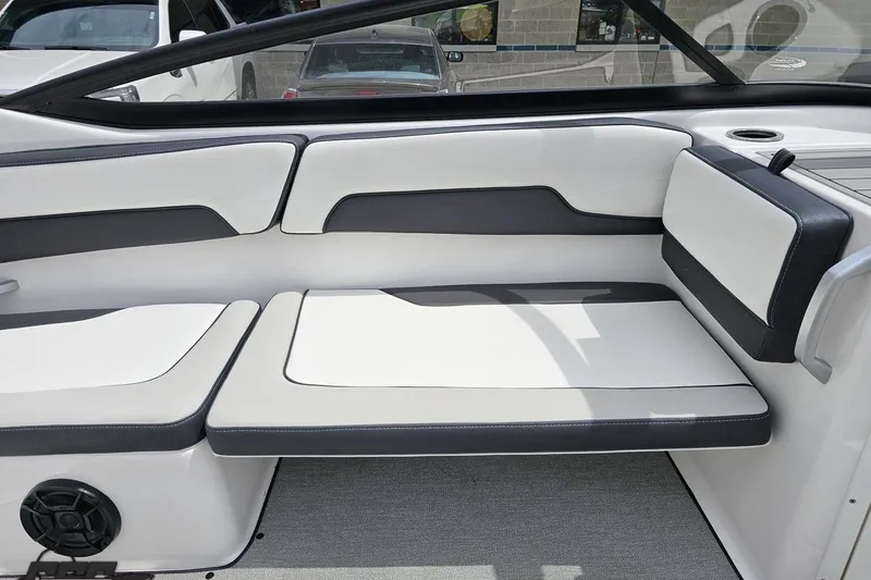 Slide: The Image of 2022 Yamaha Boats AR195 interior seating with sleek white and black upholstery. - 44