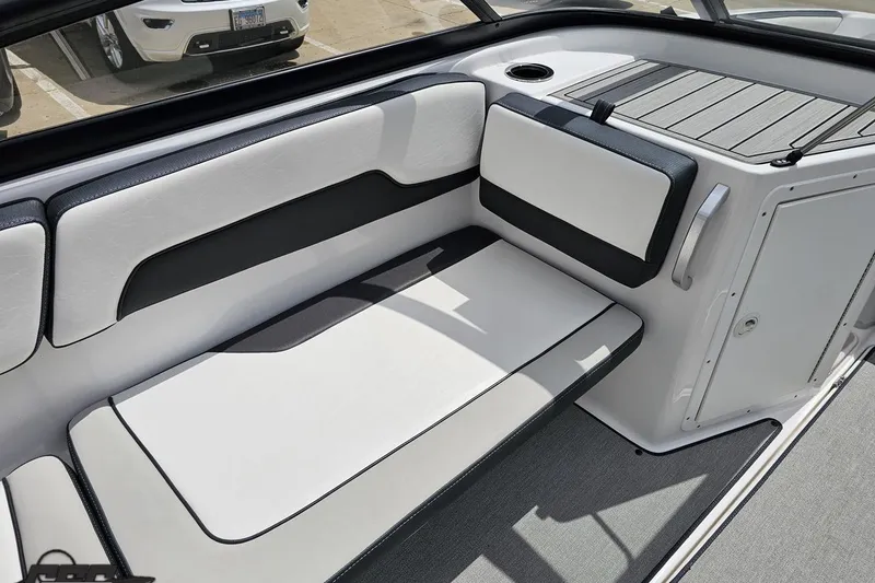 Slide: The Image of Interior seating of 2022 Yamaha Boats AR195, featuring sleek white and black upholstery. - 45