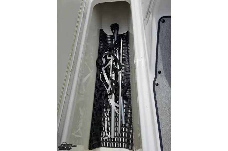 Slide: The Image of Storage compartment in a 2022 Yamaha AR195 boat, featuring organized gear storage. - 48