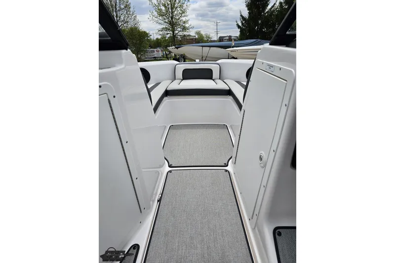 Slide: The Image of 2022 Yamaha Boats AR195 interior with gray flooring and white seating. - 51