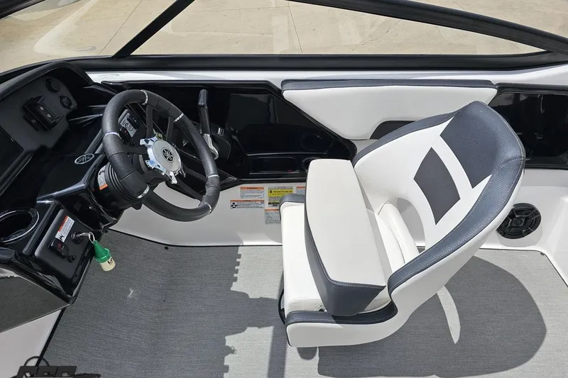 Slide: The Image of Interior of 2022 Yamaha Boats AR195, featuring steering wheel and captain's chair. - 53