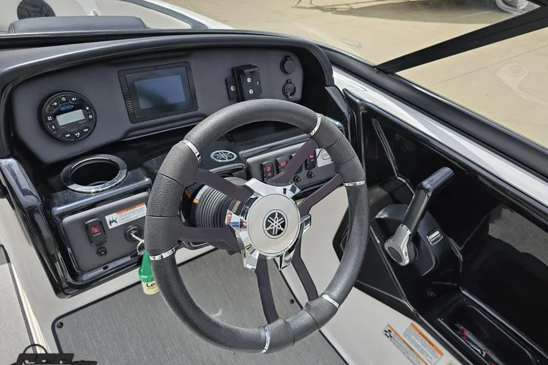 Slide: The Image of 2022 Yamaha Boats AR195 dashboard with steering wheel and control panel. - 56