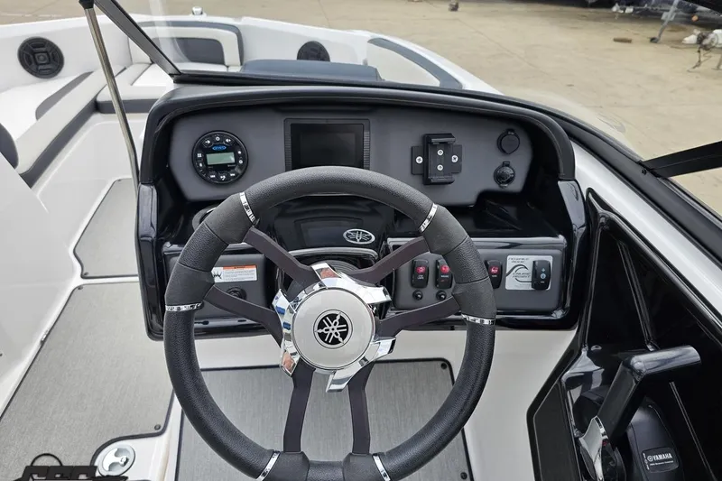 Slide: The Image of 2022 Yamaha Boats AR195 dashboard with steering wheel and control panel. - 57