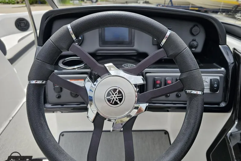 Slide: The Image of Steering wheel of 2022 Yamaha Boats AR195, featuring sleek design and control panel. - 58