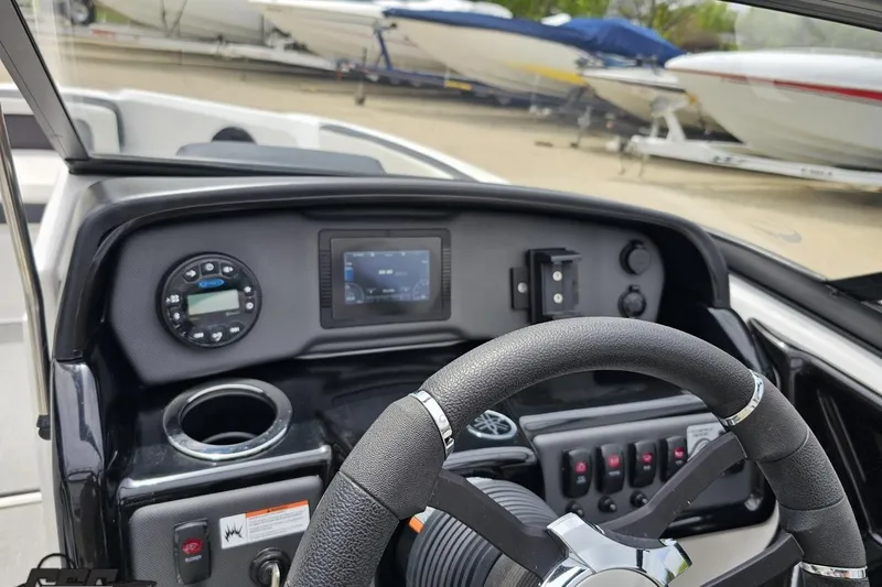 Slide: The Image of 2022 Yamaha Boats AR195 dashboard with steering wheel and control panel. - 59