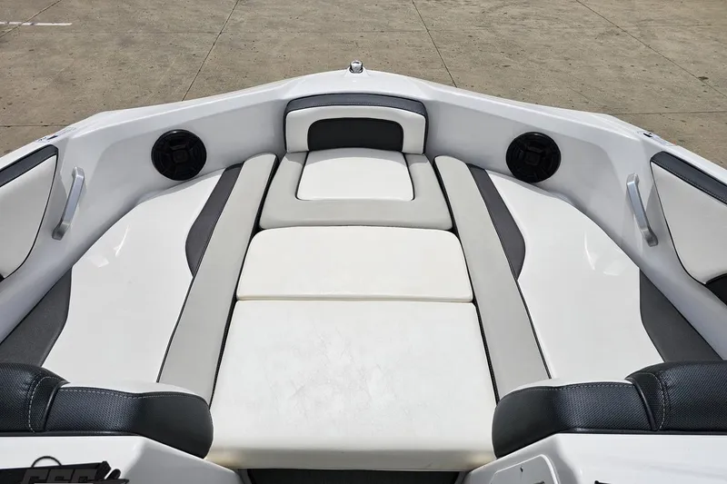 Slide: The Image of 2022 Yamaha Boats AR195 interior seating with sleek white and gray upholstery. - 65