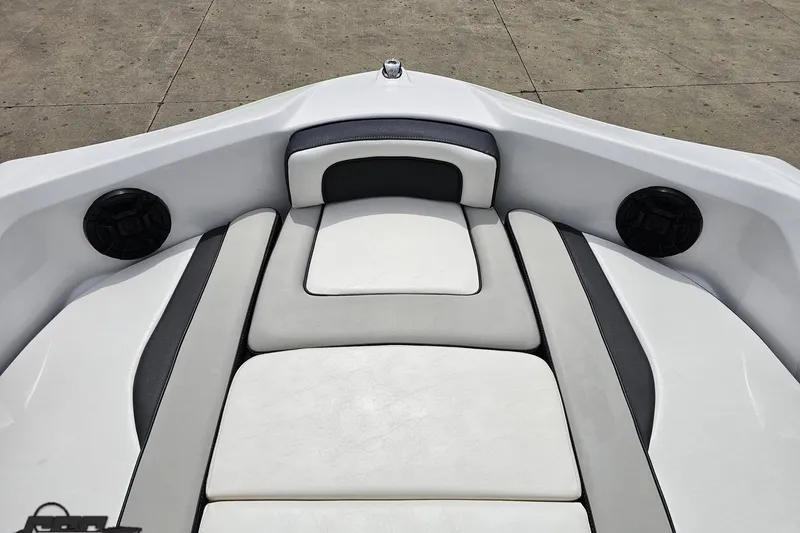 Slide: The Image of 2022 Yamaha Boats AR195 bow seating area with cushioned seats and speakers. - 66