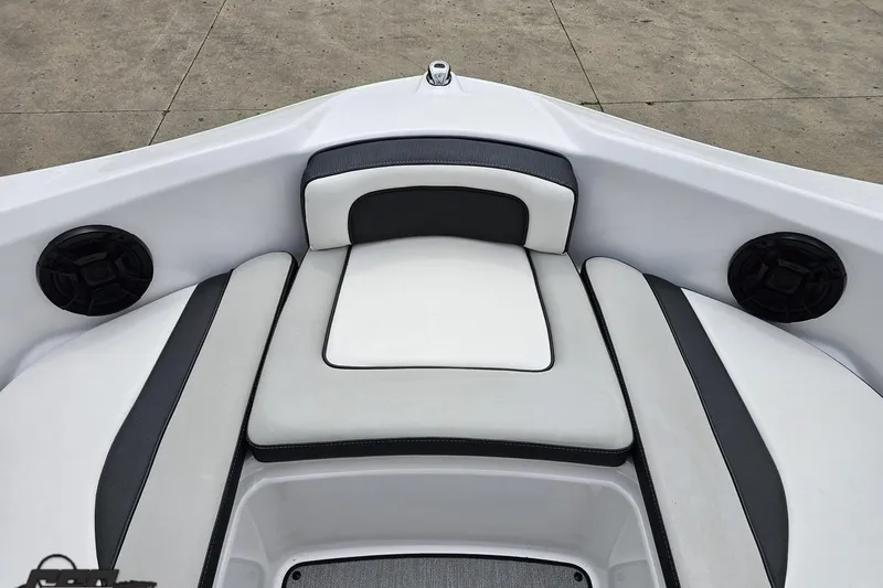 Slide: The Image of 2022 Yamaha Boats AR195 bow seating with speakers, featuring sleek white and black upholstery. - 69