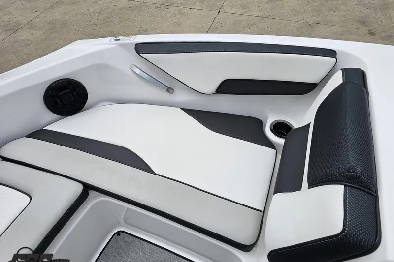 Slide: The Image of 2022 Yamaha Boats AR195 interior seating with sleek black and white upholstery design. - 70