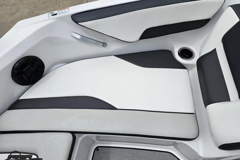 Slide: The Image of 2022 Yamaha Boats AR195 interior seating with cup holder and speaker. - 71