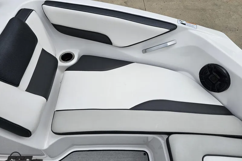 Slide: The Image of 2022 Yamaha Boats AR195 interior seating with black and white upholstery and speaker. - 74