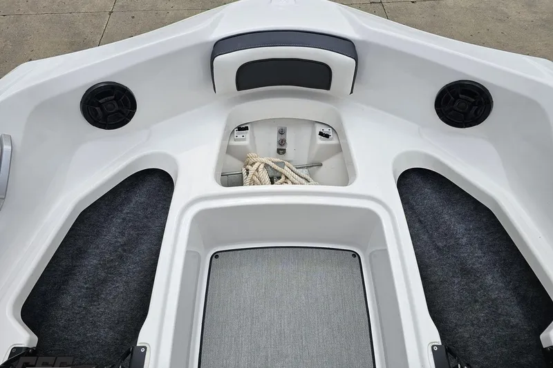 Slide: The Image of Interior view of 2022 Yamaha AR195 boat, featuring storage and speakers. - 75